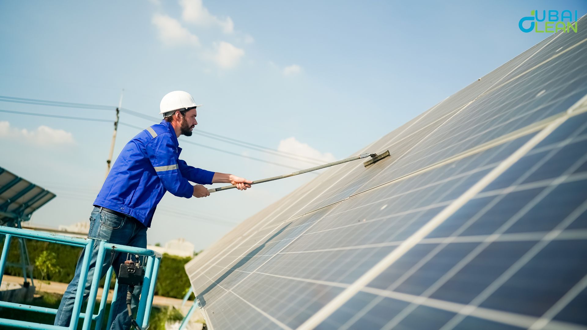 Technician cleaning solar panels on a rooftop in Dubai to improve efficiency.