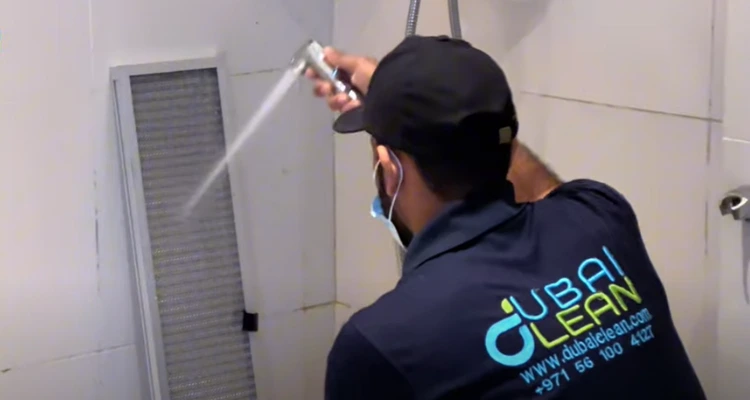 Technician cleaning dusty AC coil with specialized tools to improve cooling performance