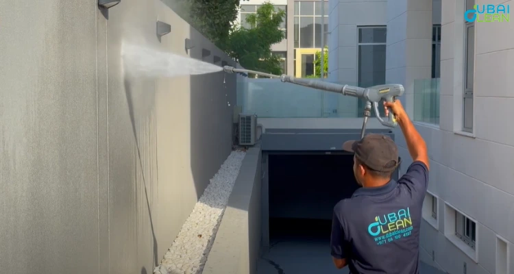 Facade cleaning service in progress on a high-rise building with visible shine and clarity