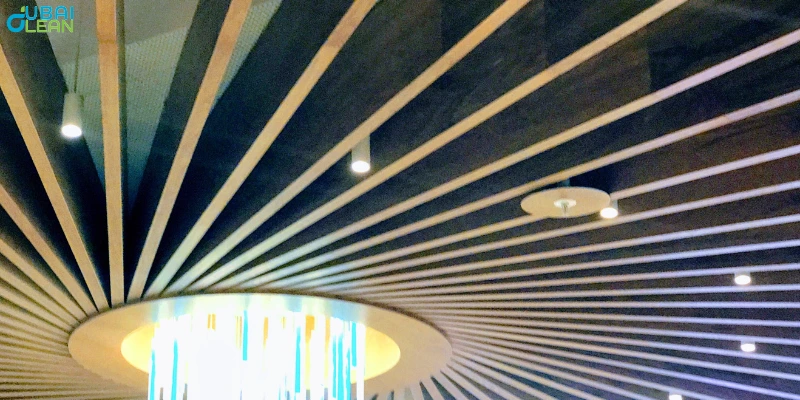 Skilled worker repairing false ceiling panels using modern tools